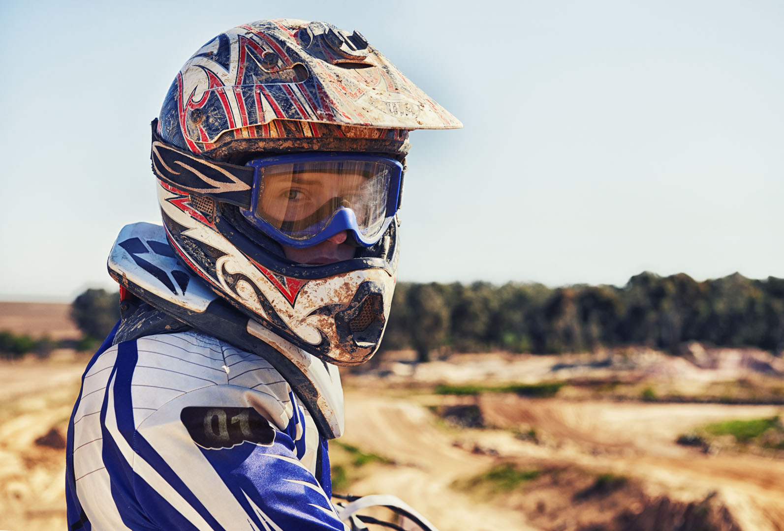 Time to rip up this track. Portrait of motocross rider looking b